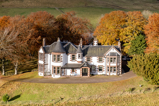 Exterior of Kinclune House with autumnal trees surrounding